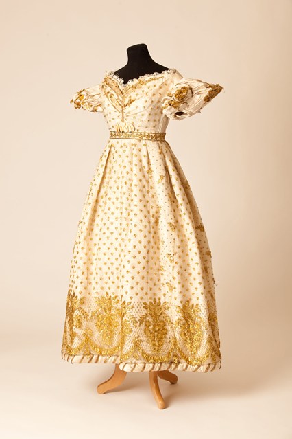 Ball dress of cream silk net embroidered in gold metal strip, late 1820s